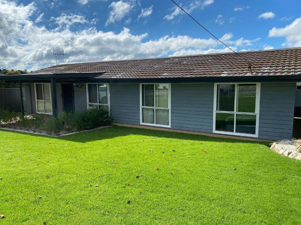 A House With a Lush Green Lawn in Front of It — All Things Windows & Doors in Goulburn, NSW