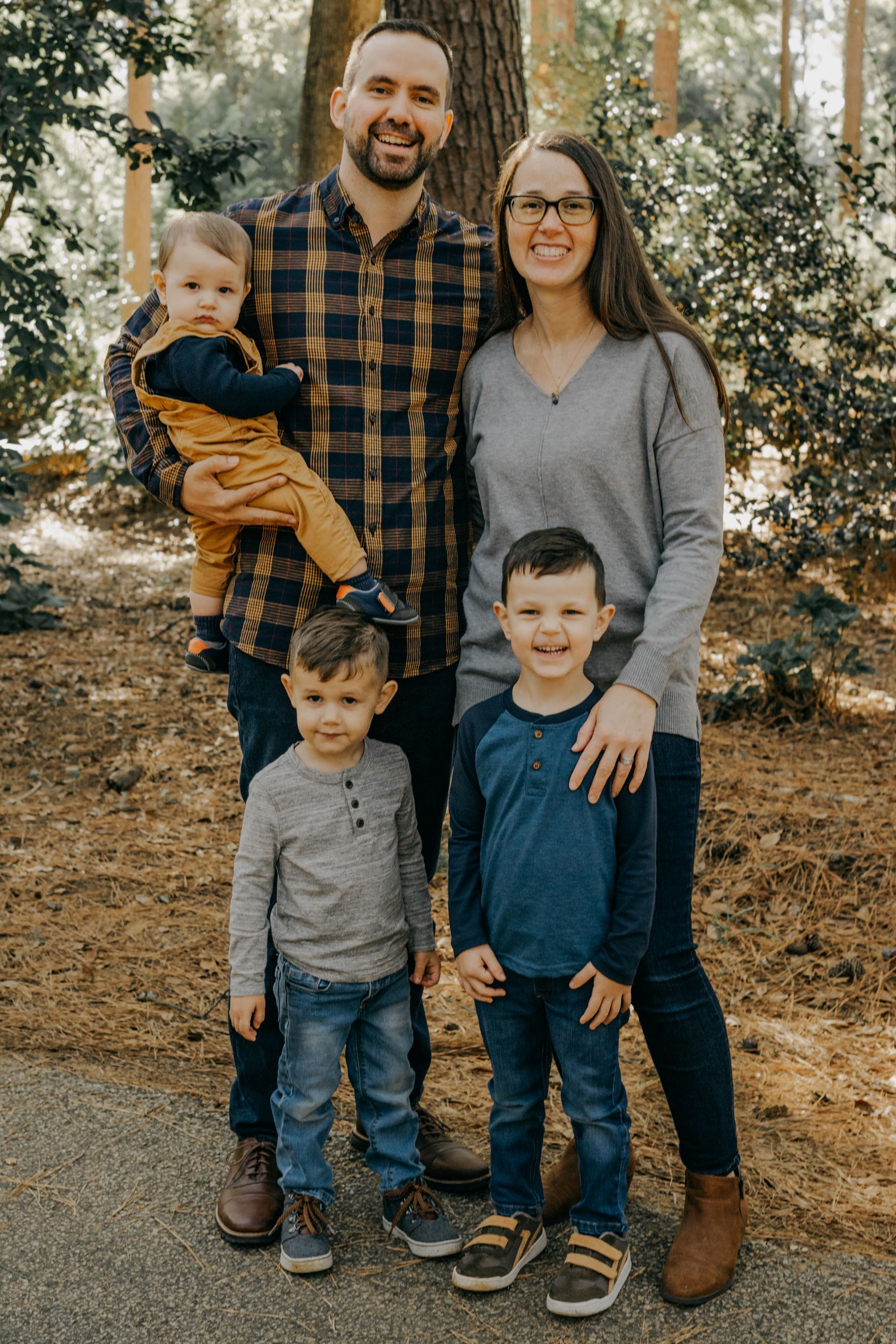 Bullard family posing outdoors. Father holds a baby, two young boys stand in front, mother beside them.