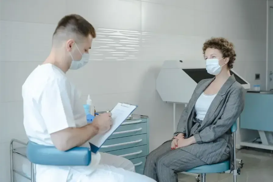 A rhinologist consulting with a patient before endoscopic sinus surgery.
