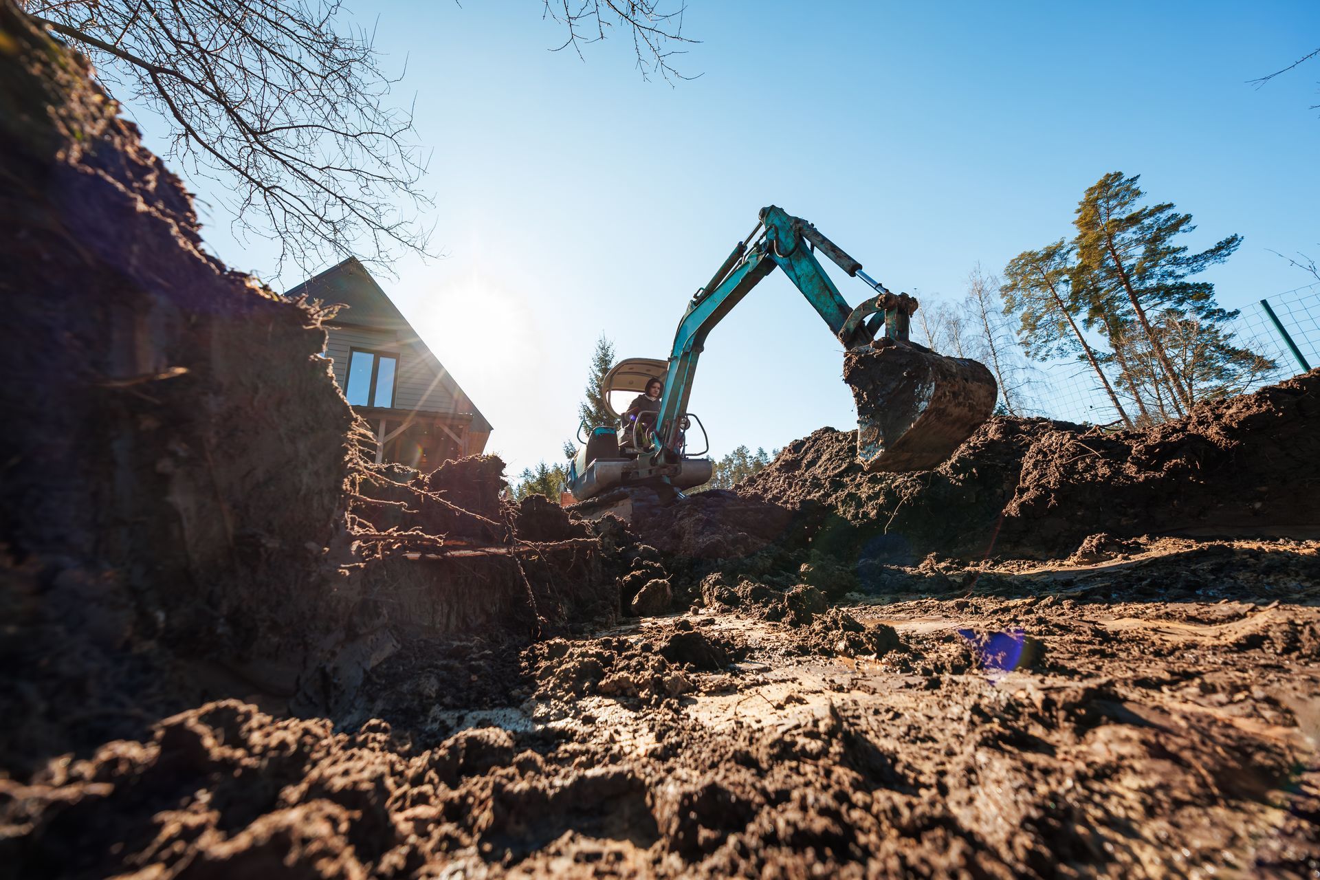 Excavator digging dirt at a construction site.