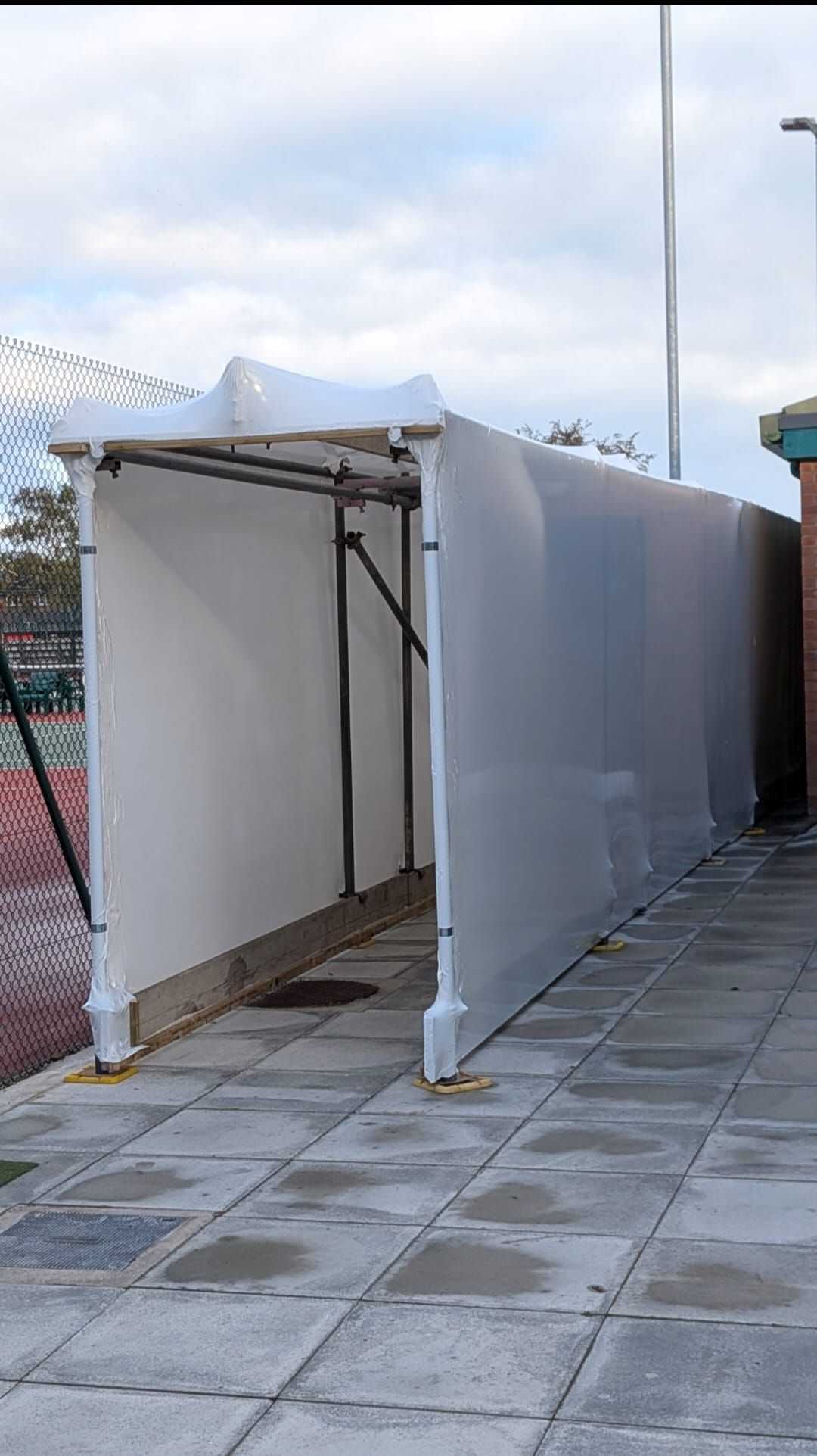 Scaffold spectator walkway with shrink-wrap covering at Wrexham Tennis & Padel Centre