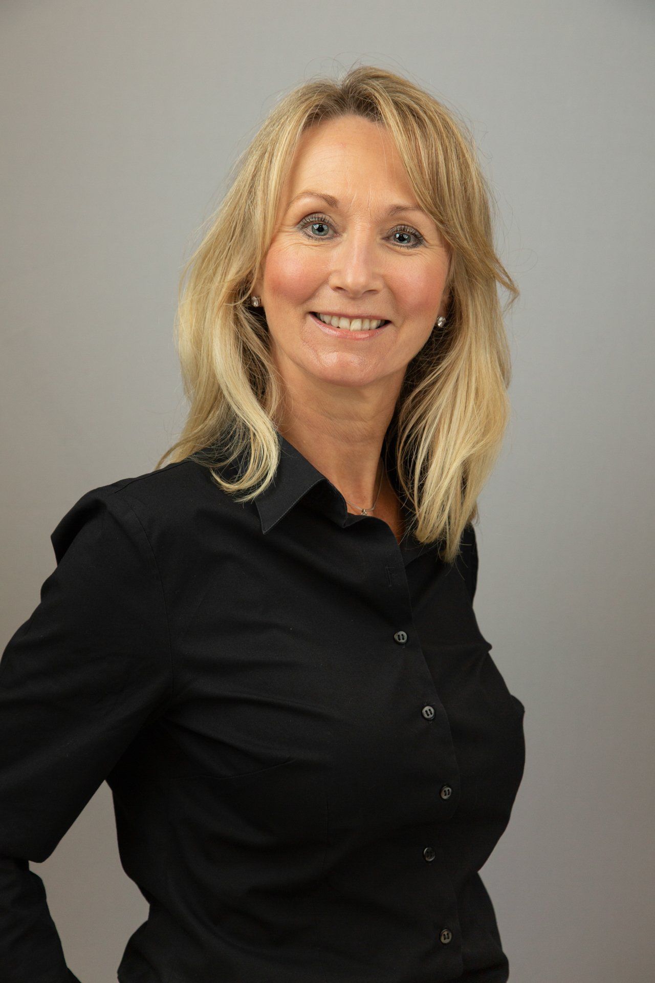 Corporate headshot in Leeds studio of a woman wearing  a black blouse