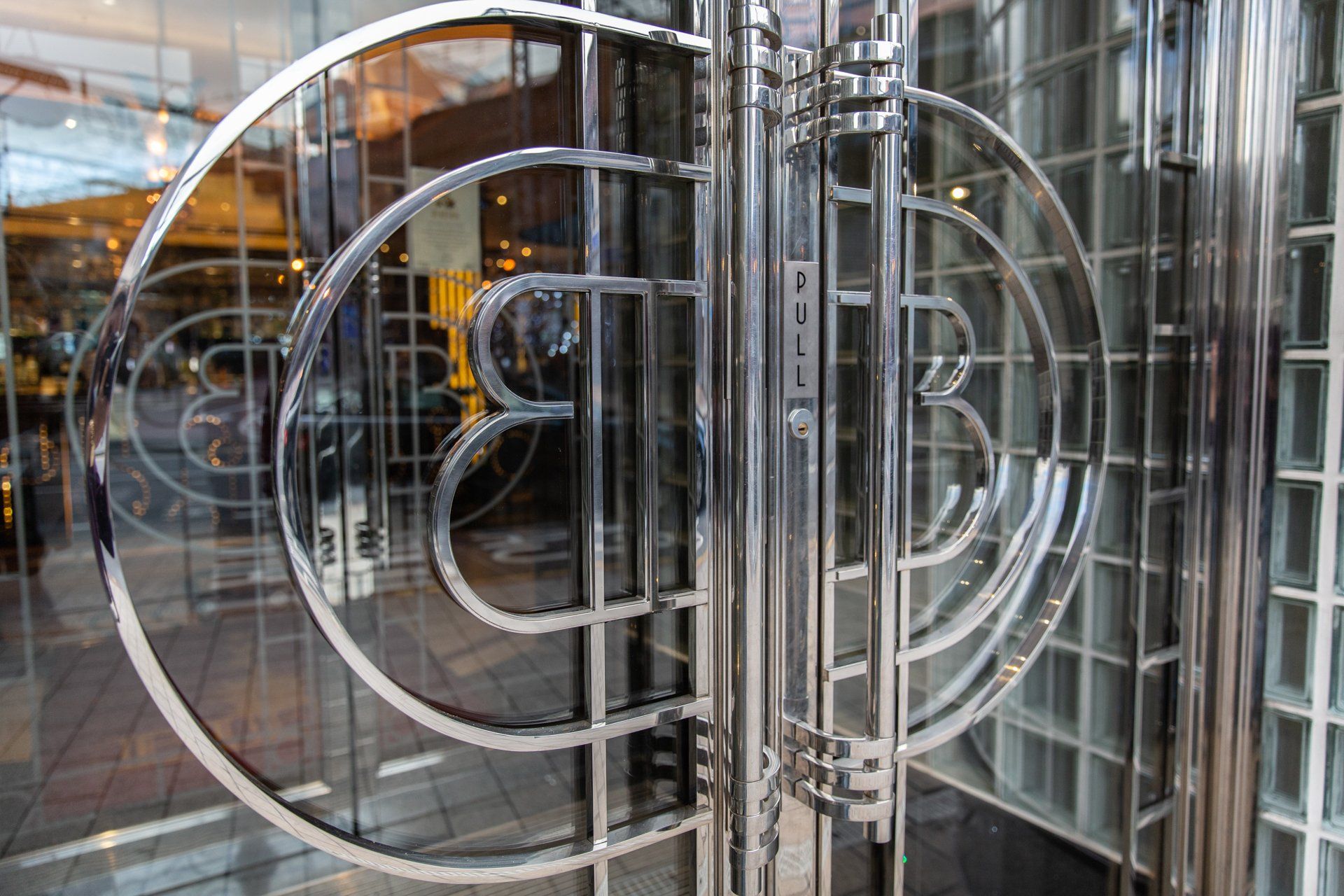 A stainless steel door with a circular design on it
