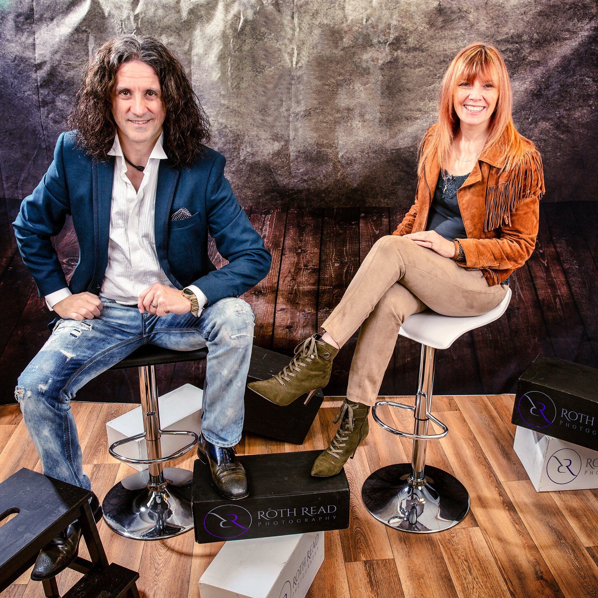 A man and a woman are sitting on bar stools