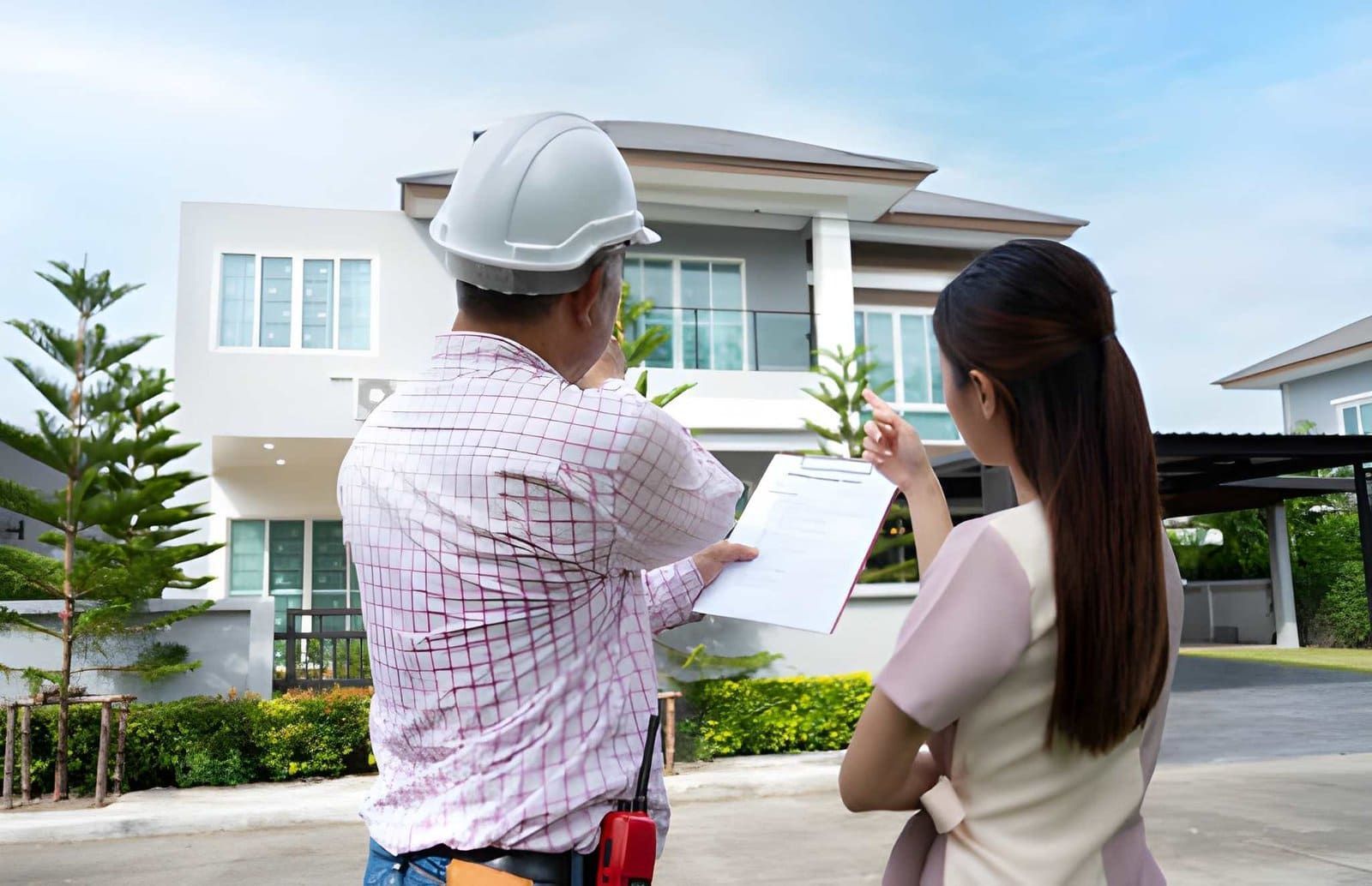 Home inspection Palm Beach Gardens FL professionals assessing modern two-story house with clipboard
