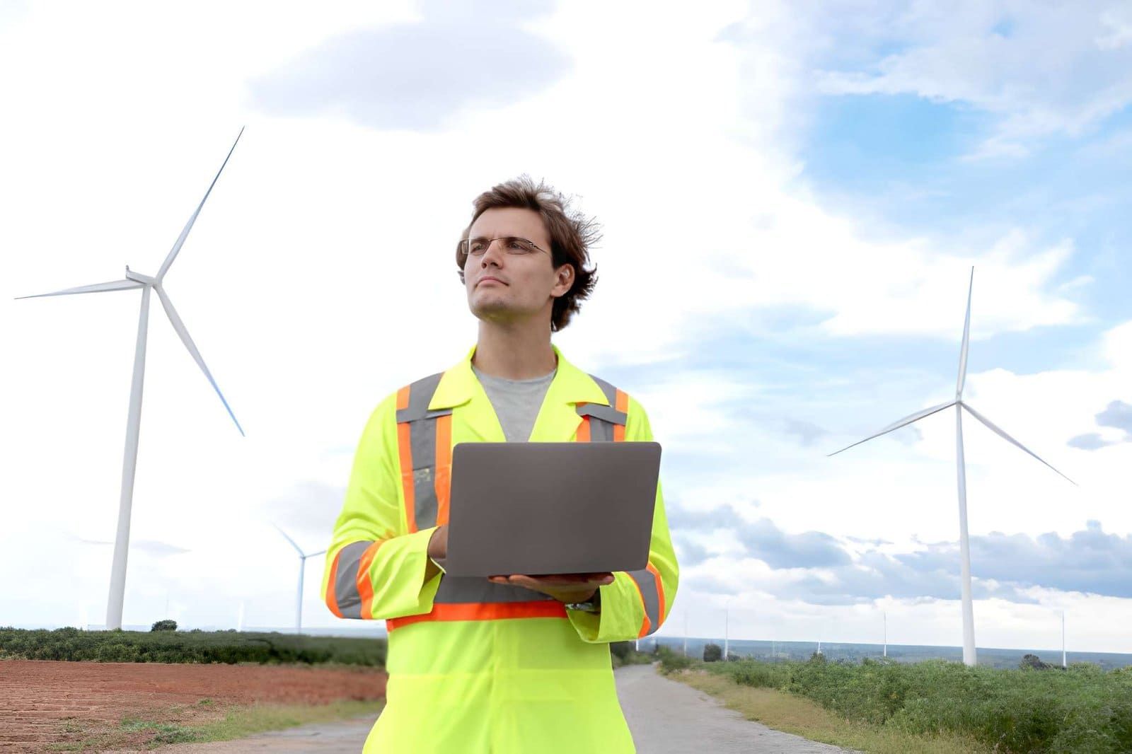 Wind mitigation inspection Vero Beach FL professional in safety jacket using laptop.