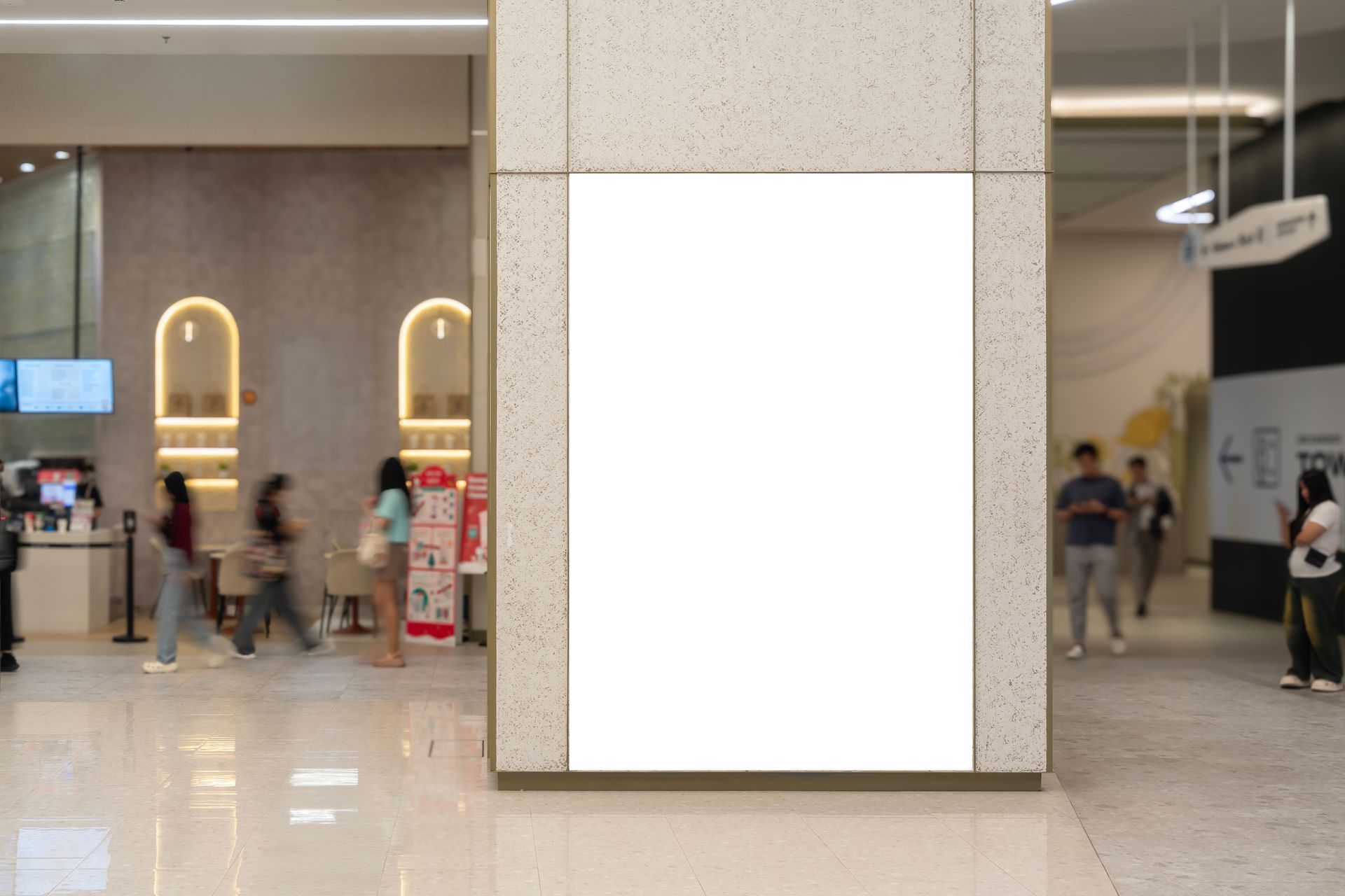 A blank vertical interior wall sign mockup mounted on a column inside a commercial retail corridor