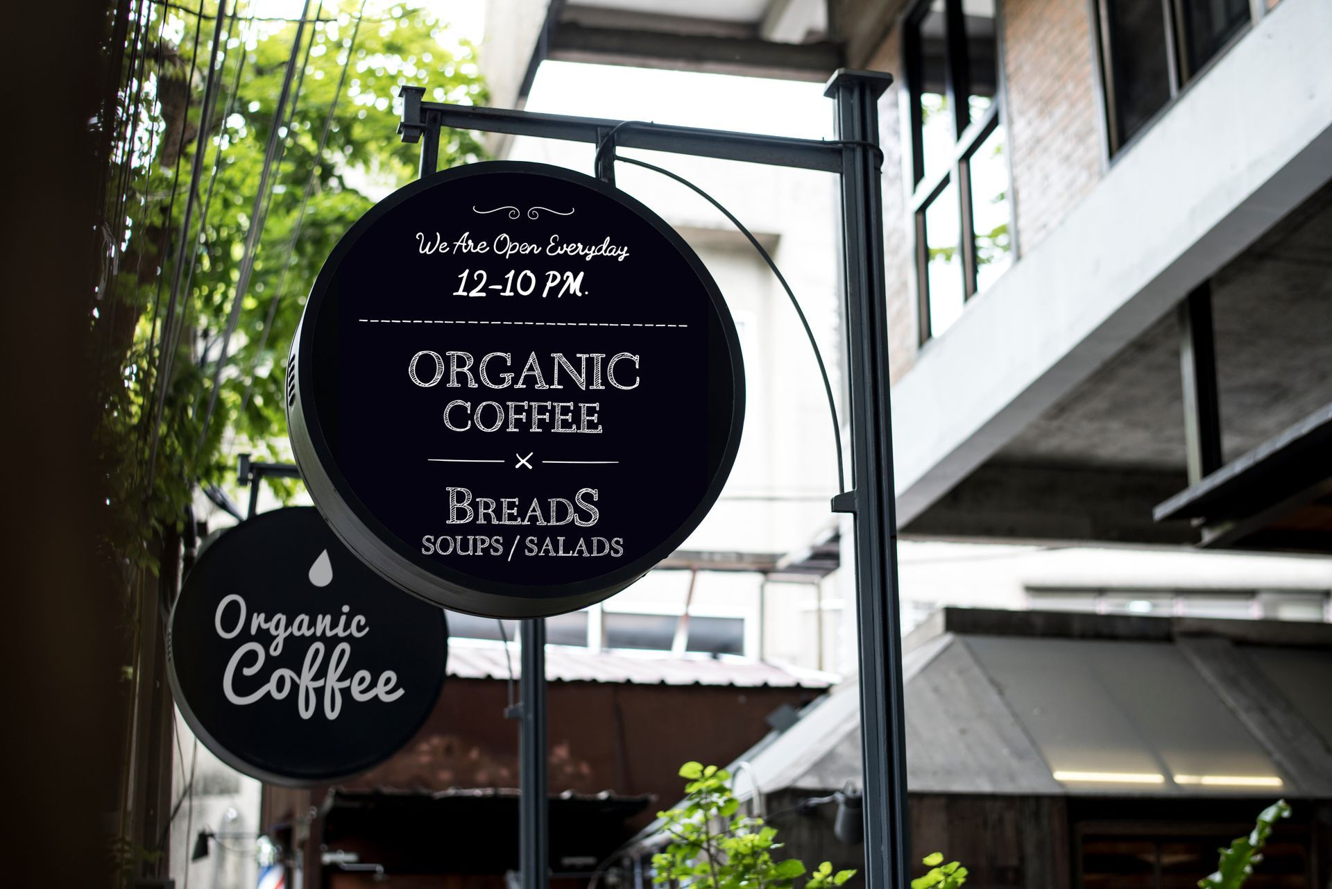Organic coffee shop sign advertising coffee, breads, soups, and salads.