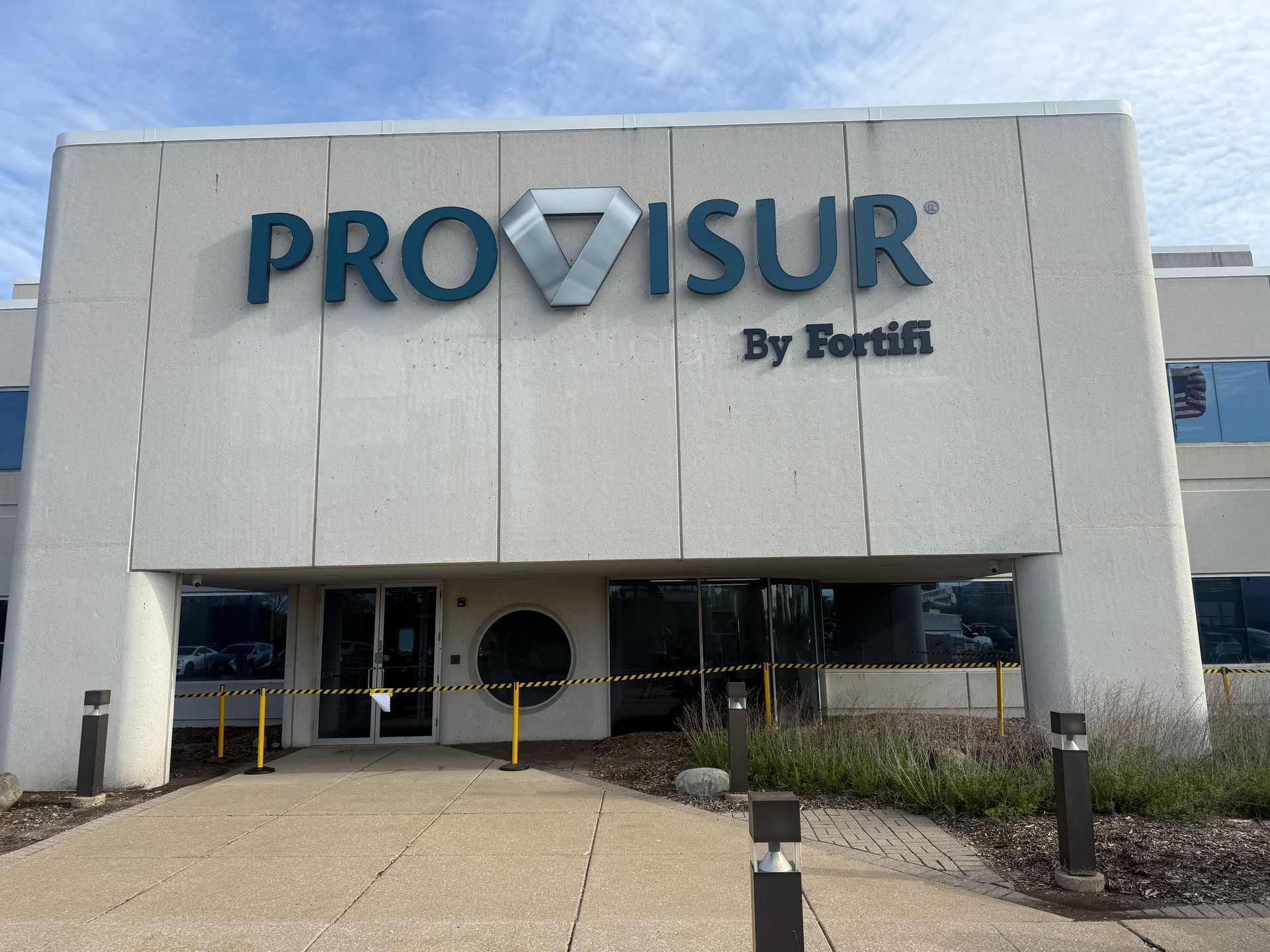 Provisur office building facade with large blue logo above the entrance
