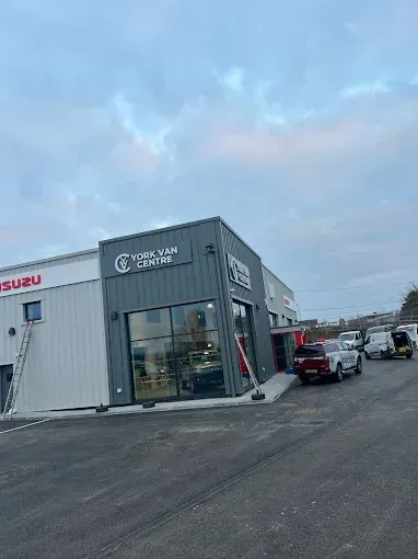 York Van Centre building with parked vehicles and overcast sky.