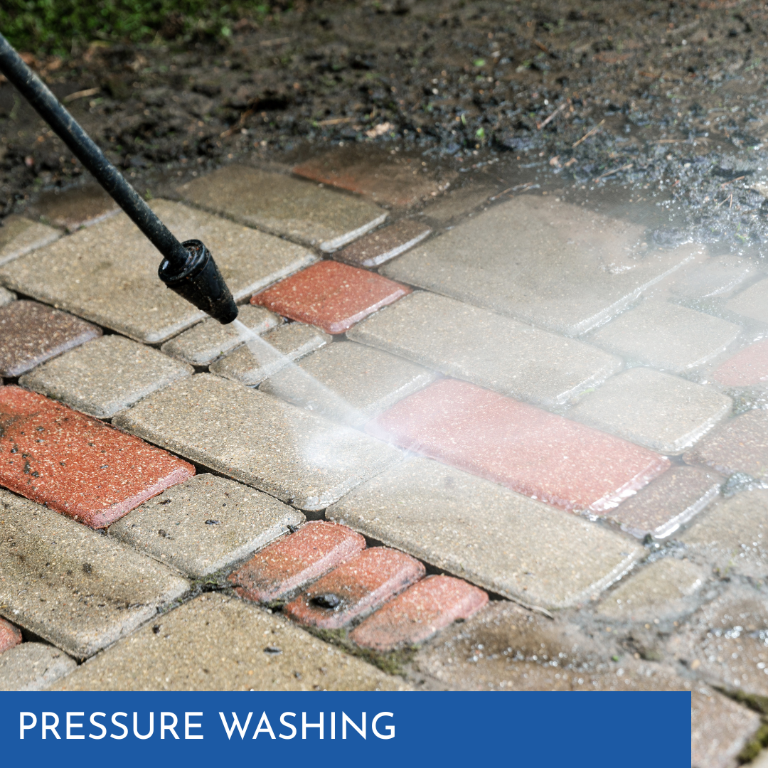 Pressure washer cleaning red and gray brick pavers.