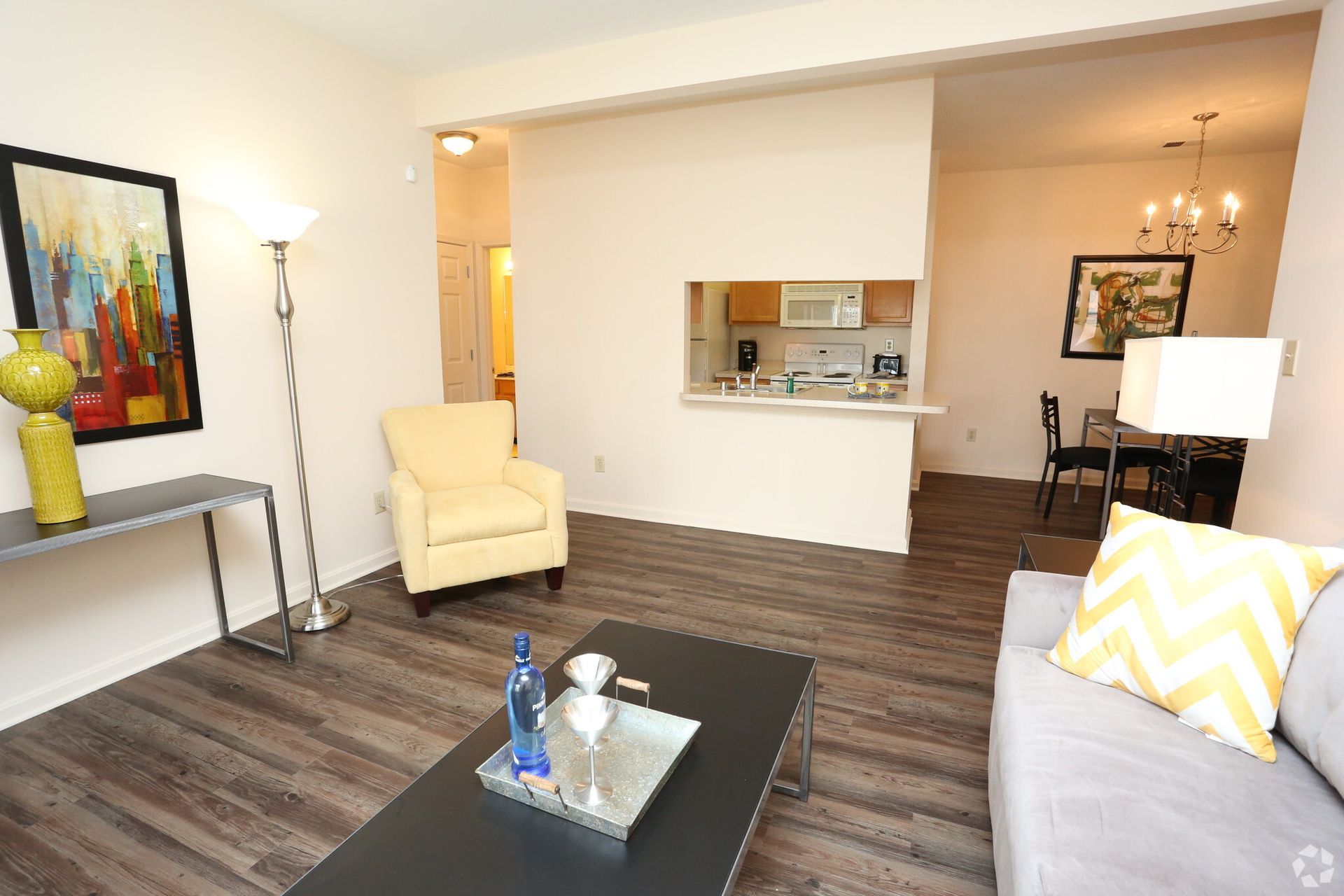 A living room with a couch , chair and coffee table