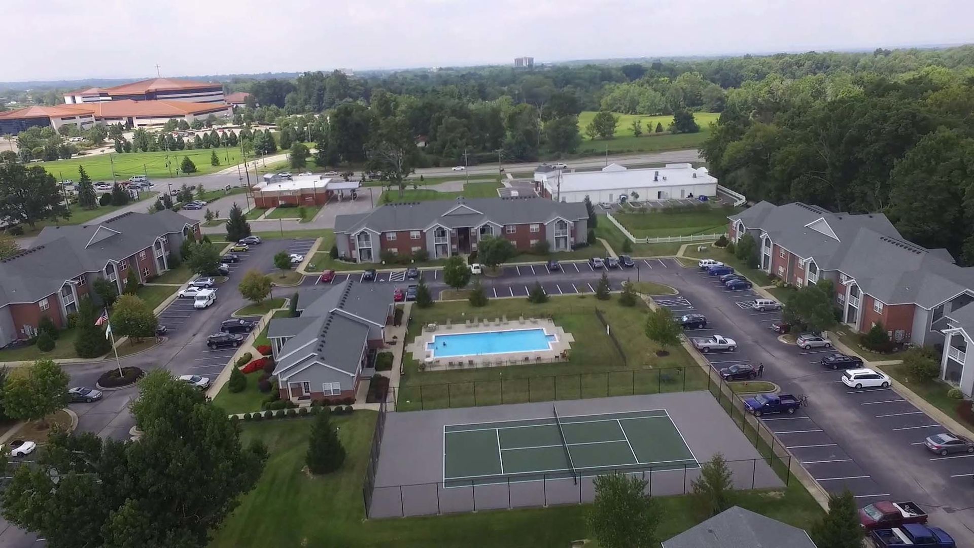 An aerial view of a residential area with a swimming pool