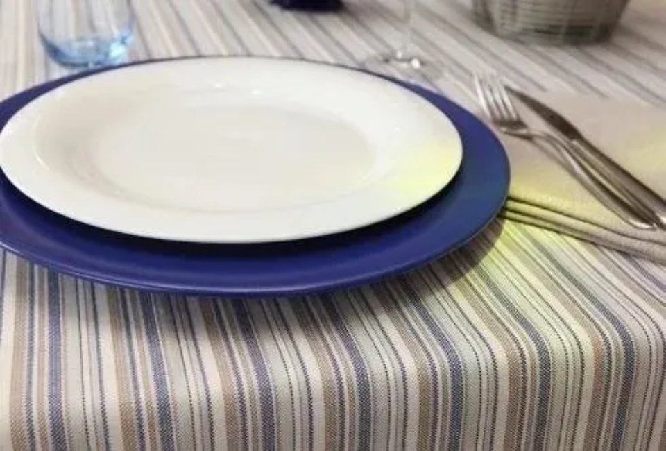 striped tablecloth with plates on top