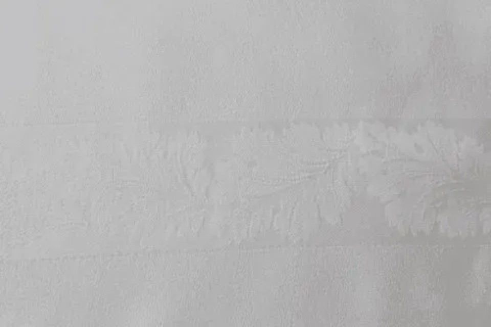 white towel with leaf themed embroidery