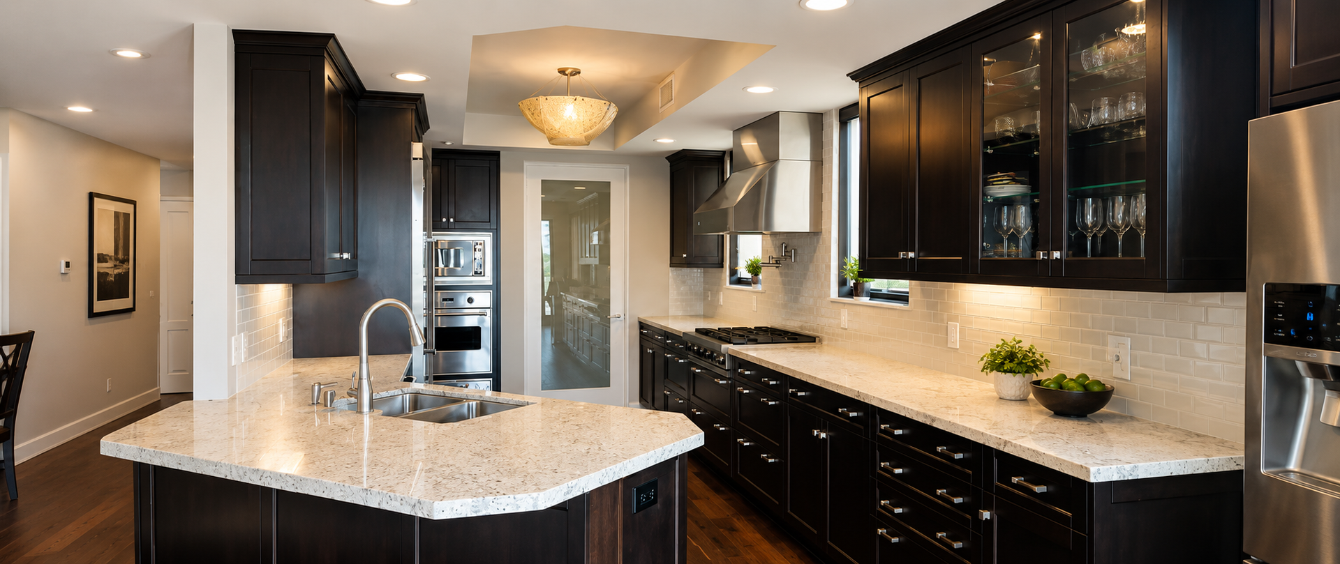 Modern kitchen with dark cabinets, granite island, and stainless steel appliances