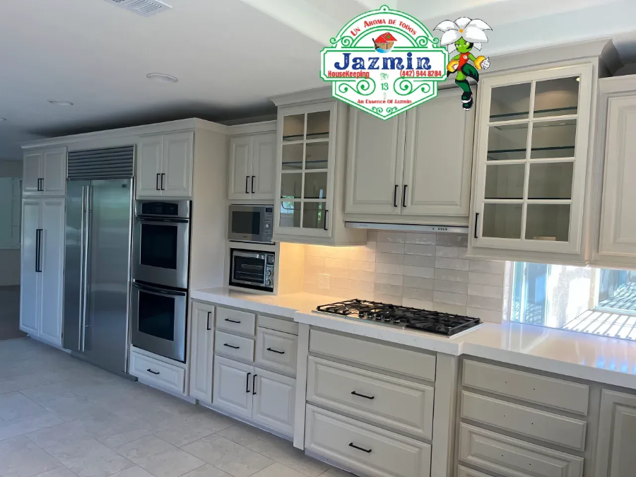 Bright modern kitchen with white cabinets, stainless steel appliances, and a large island countertop