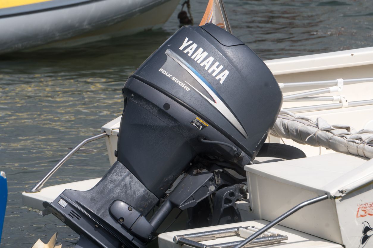 Yamaha outboard motor mounted on a small boat in the water, viewed close up from the stern.