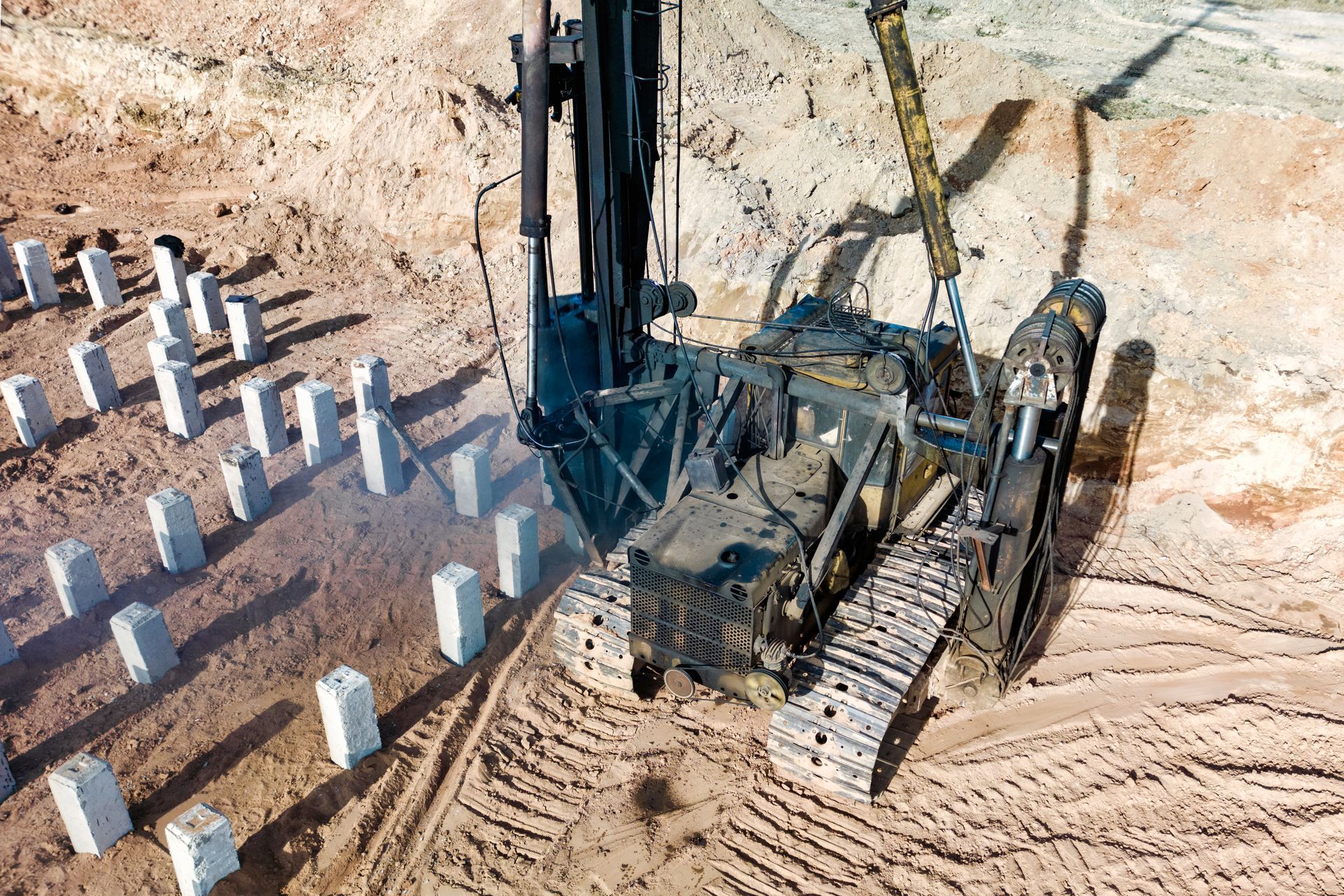 A pile driving machine preparing a pile foundation on a construction site. A pile driving machine preparing a pile foundation on a construction site.
