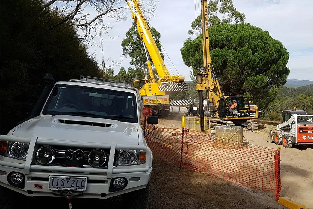 White Car and Drilling Heavy Machines — Toorak, VIC — A Access Piling and Rock Drilling White Car and Drilling Heavy Machines — Toorak, VIC — A Access Piling and Rock Drilling