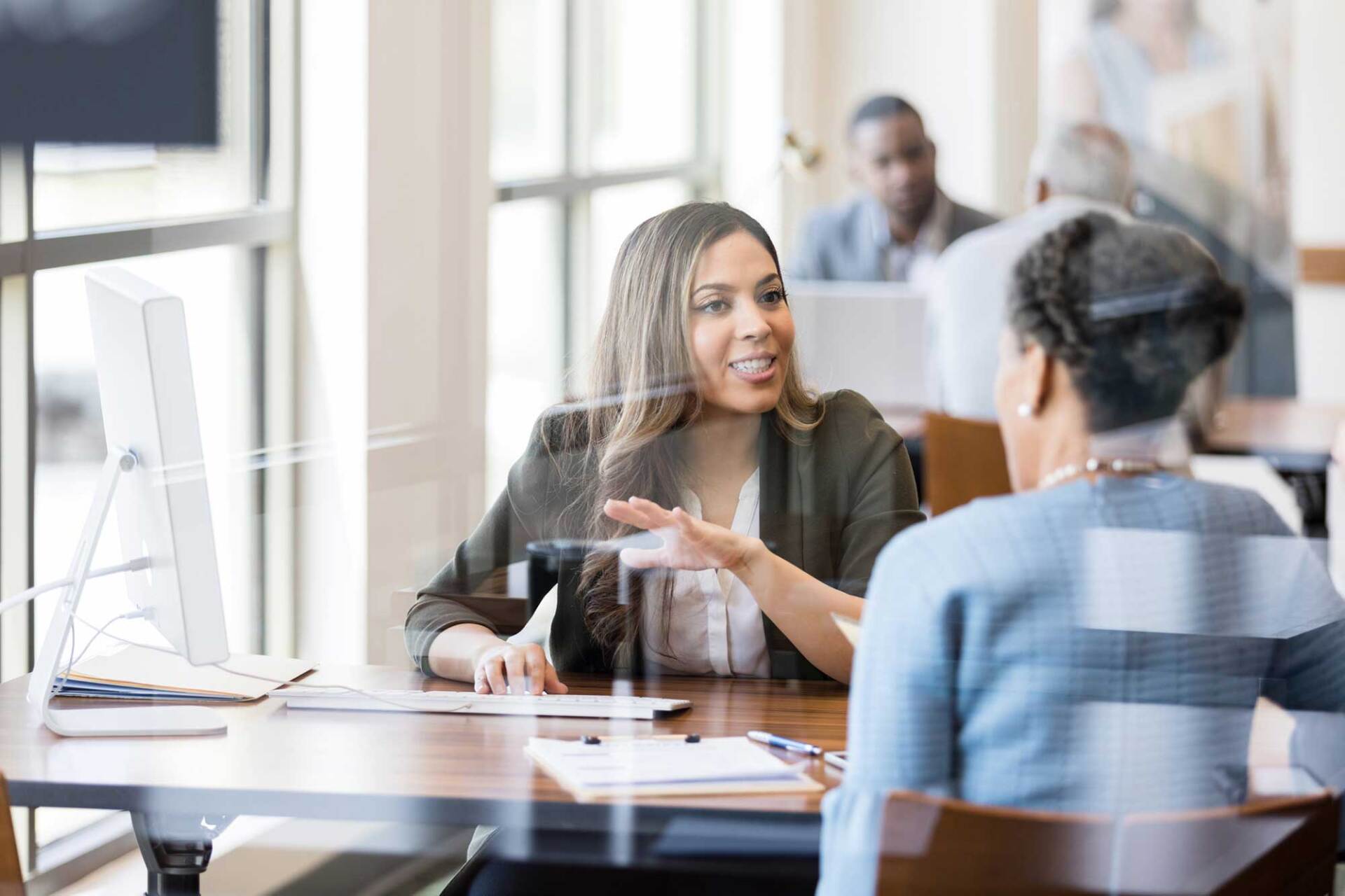 Female Employee Talking to a Client — Missoula, MT — McNay & Messick, CPAs, PC