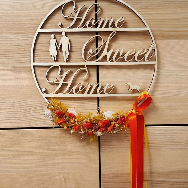 An einer Wand hängt ein Schild mit der Aufschrift „Home Sweet Home“