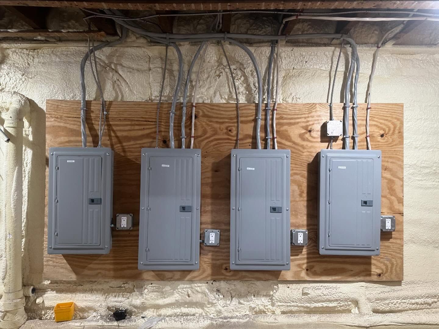 A bunch of electrical panels are hanging on a wall.