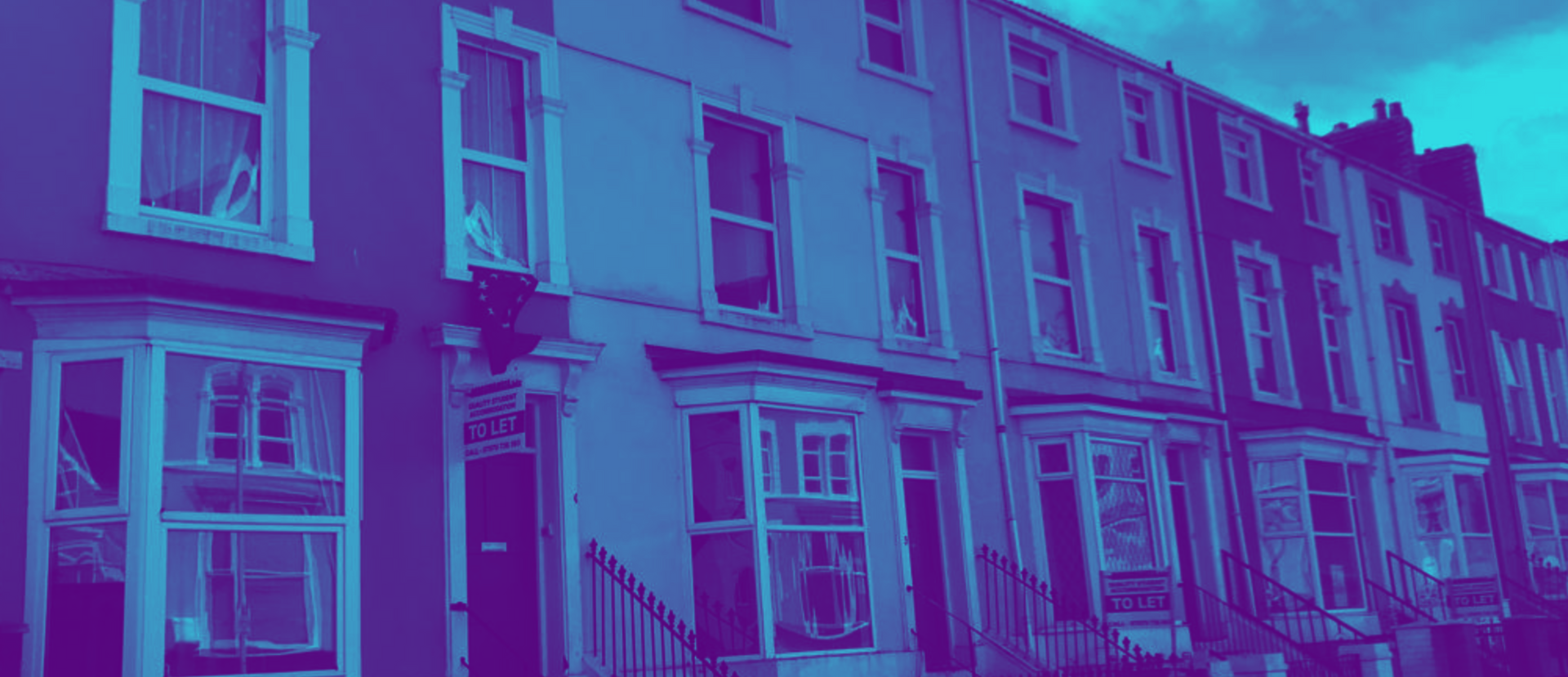 Row of houses with bay windows, painted in shades of blue and purple.