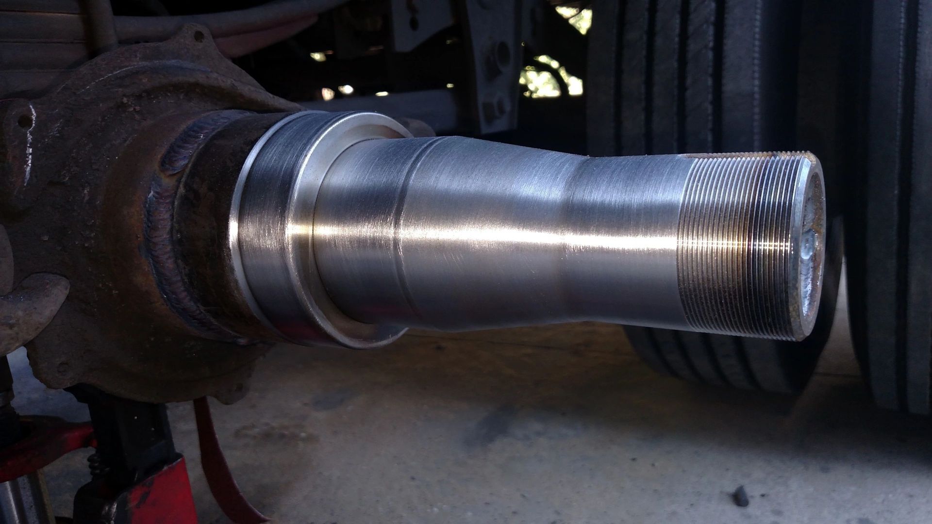 A close up of a metal shaft on a vehicle