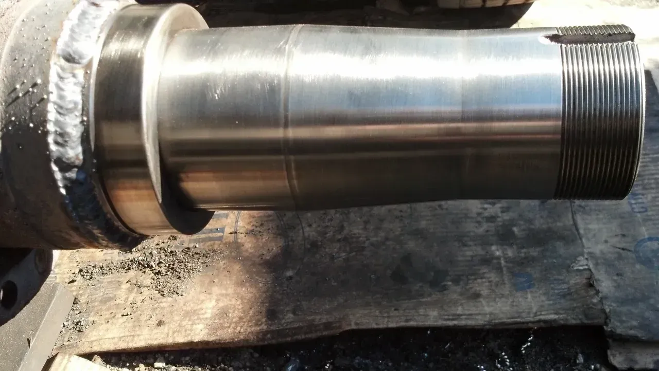 A close up of a metal shaft with a hole in it