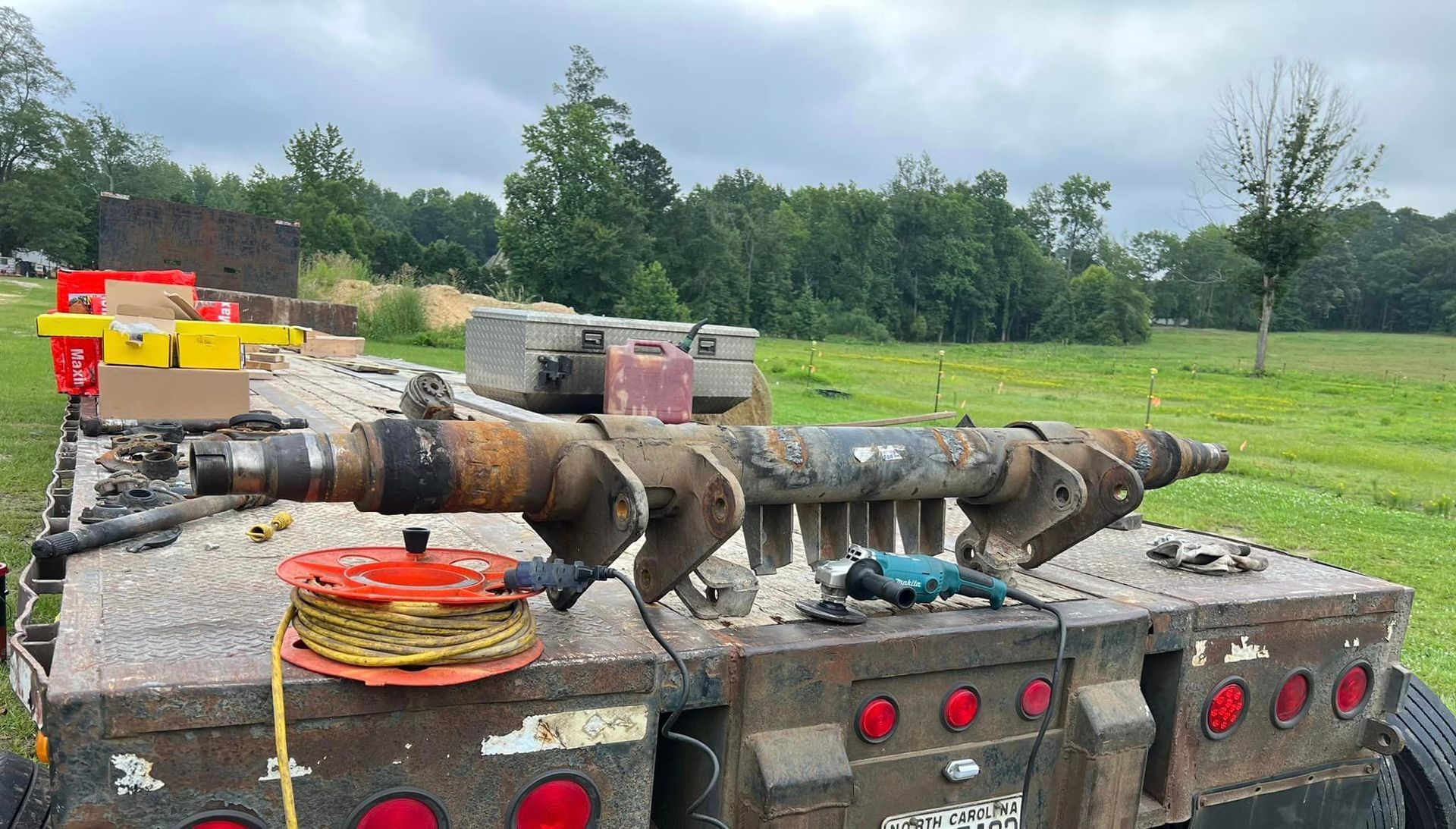 A large piece of equipment is sitting on the back of a truck.