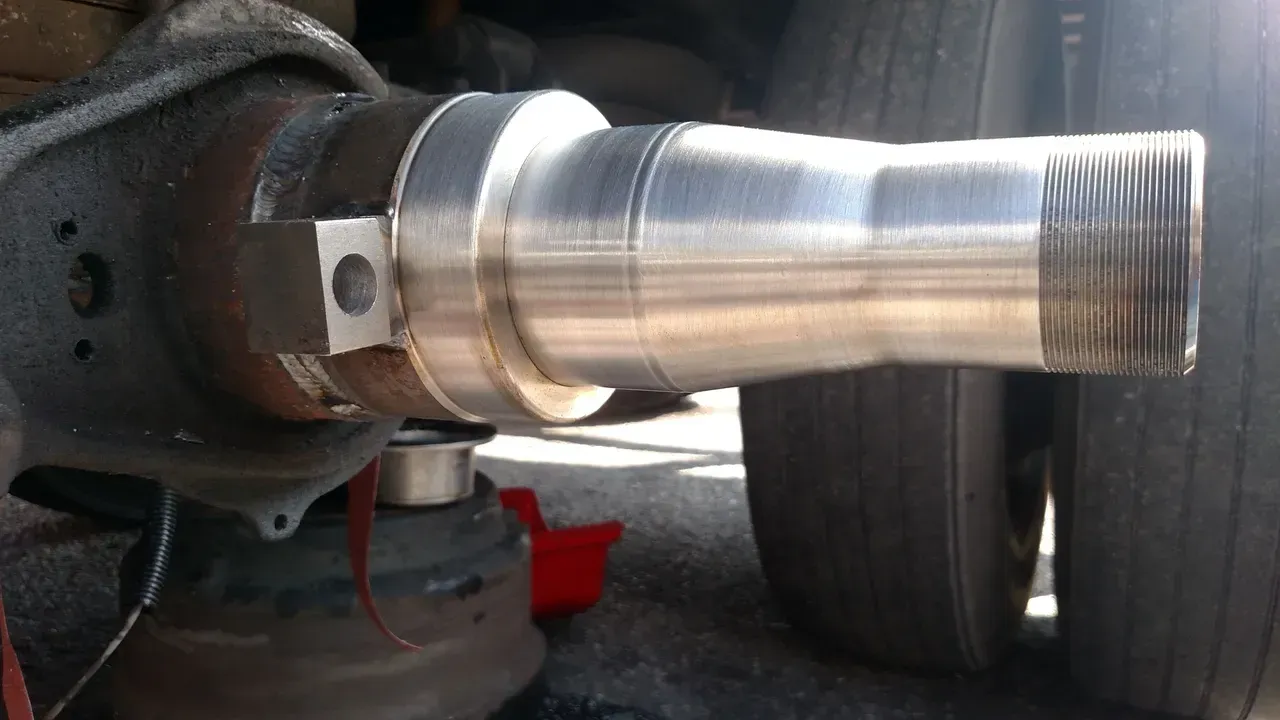 A close up of a metal pipe with a hole in it