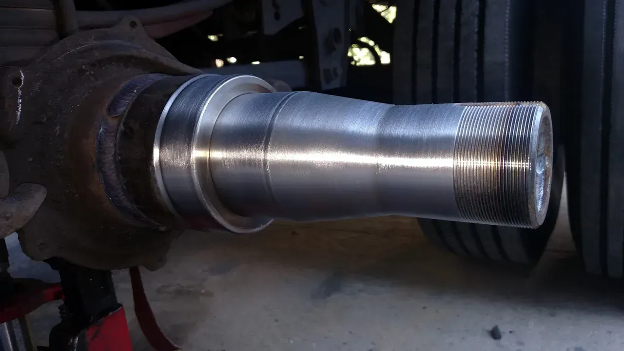 A close up of a metal shaft on a vehicle