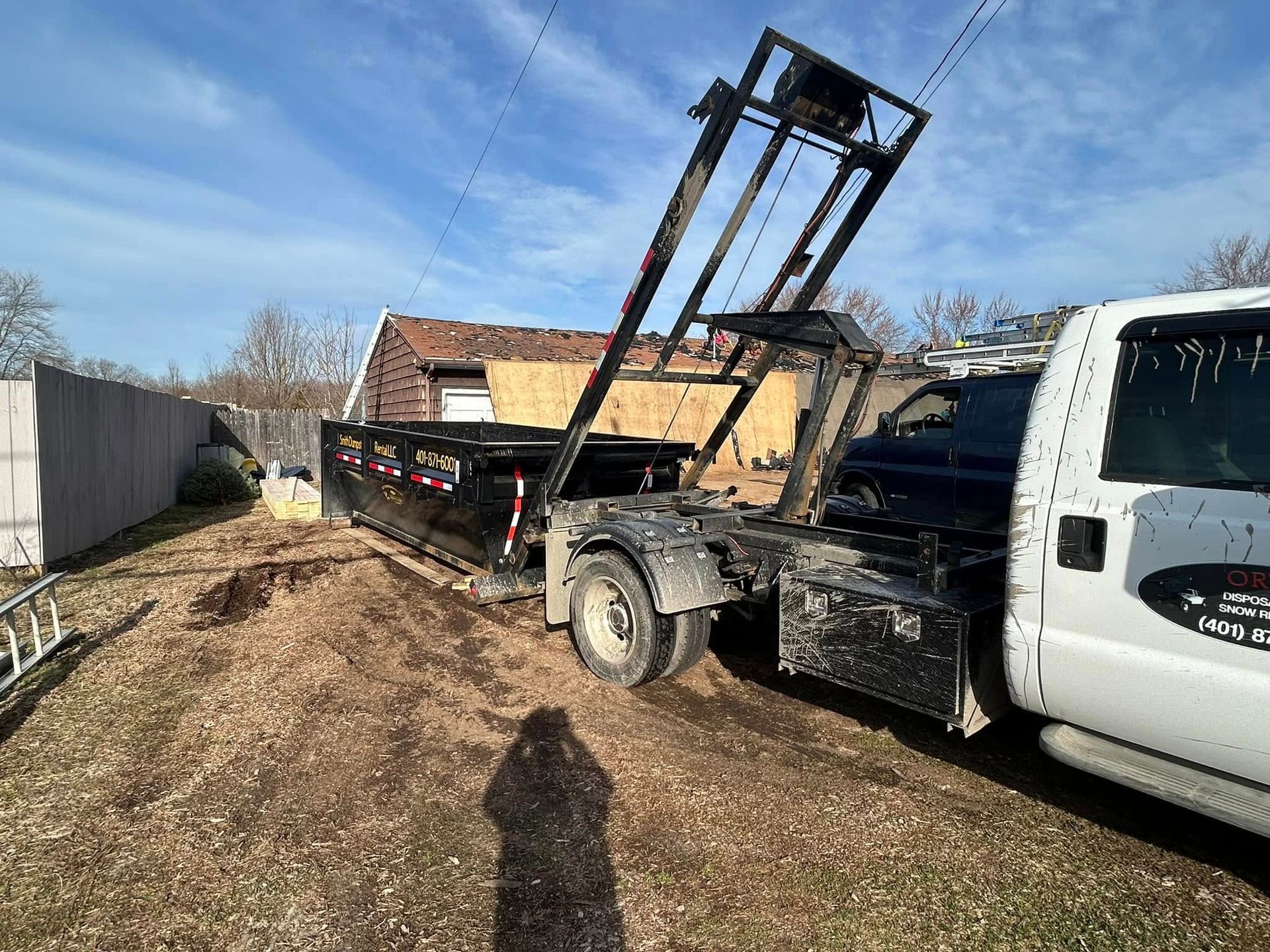 A dump truck is parked in front of a house.
