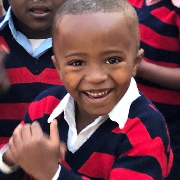 OneLove Ethiopia students smiling. One Love helps provide a safe education to students..