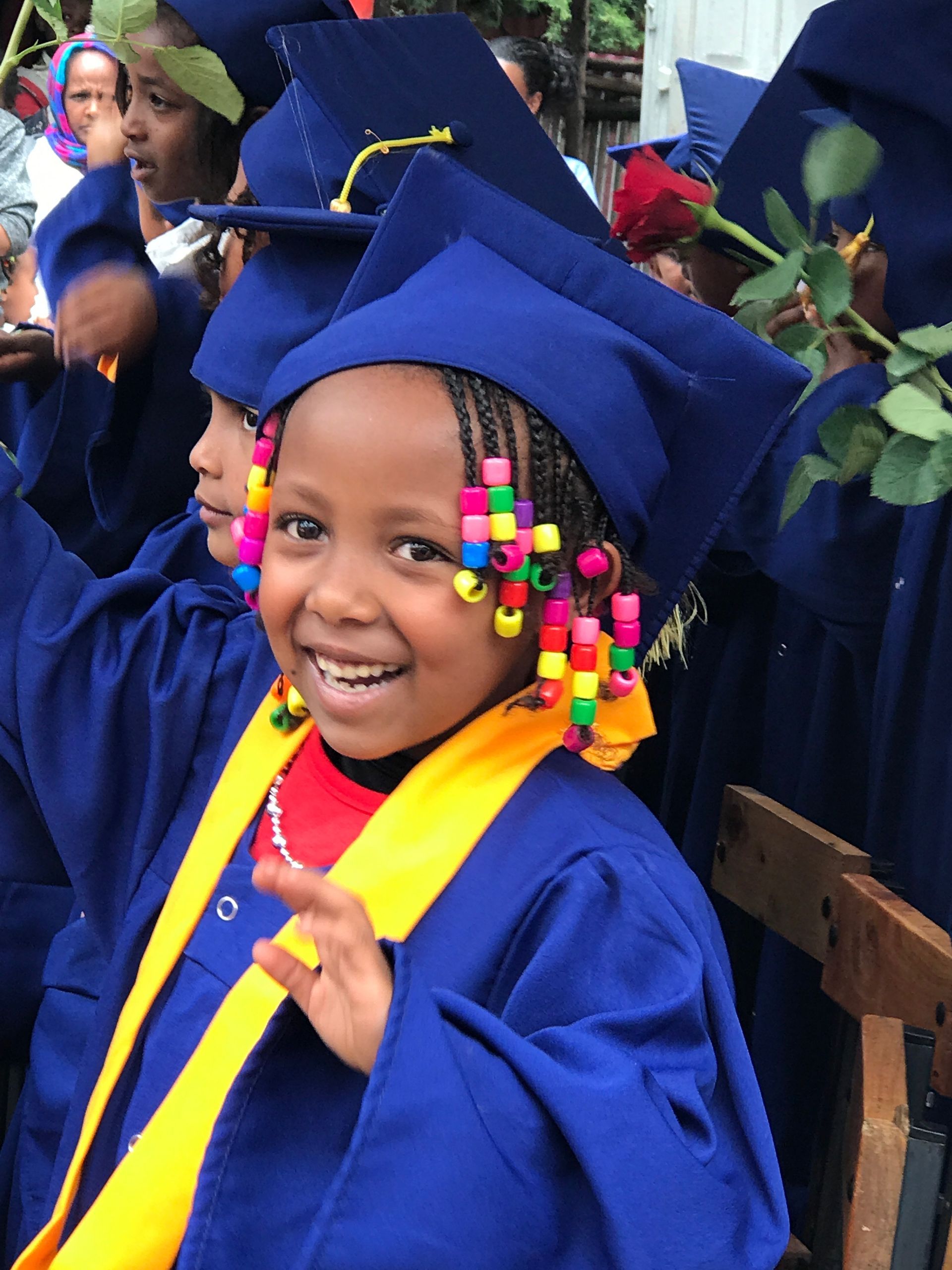 OneLove Ethiopia students smiling from graduation. One Love helps provide a safe education to students..