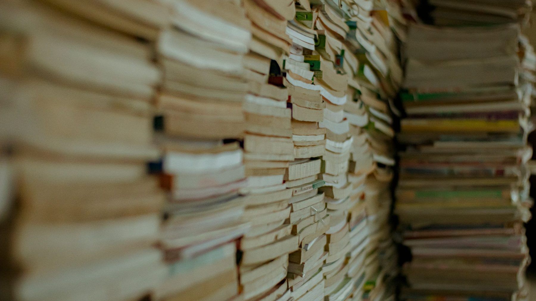 A wall of stacked paper files seen edge on