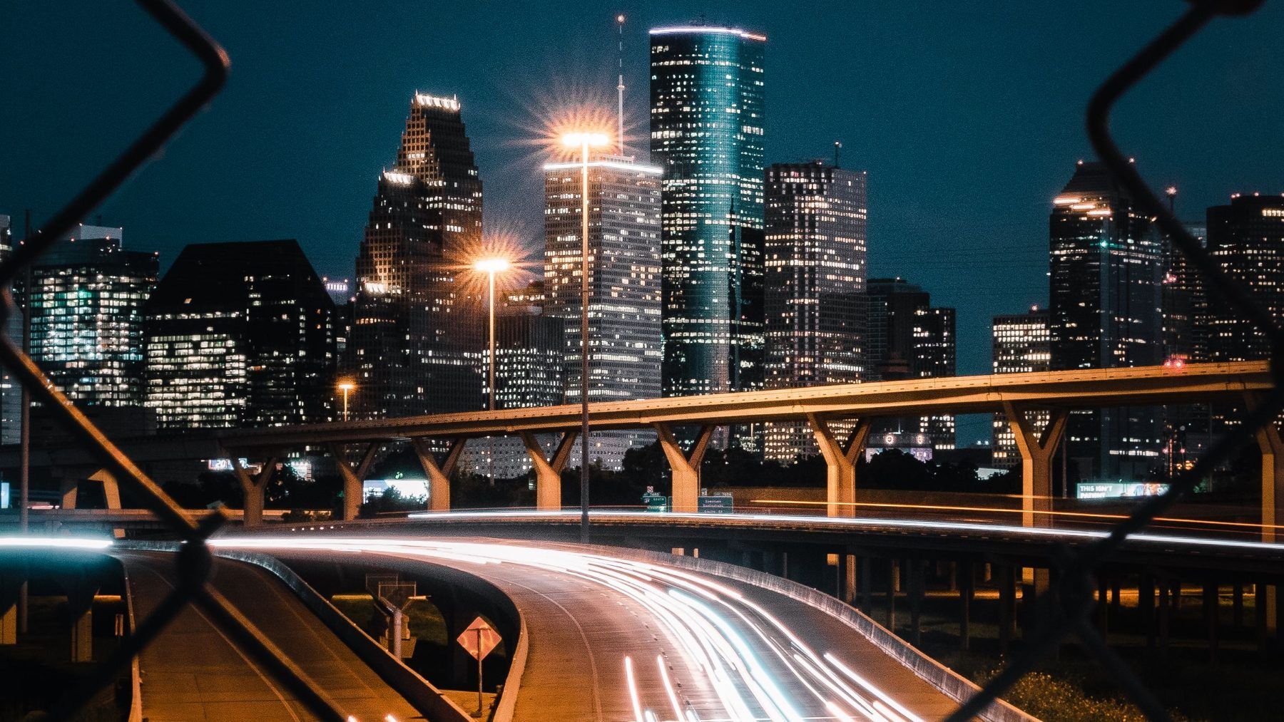 The Houston skyline and freeway at night seen through a windshield