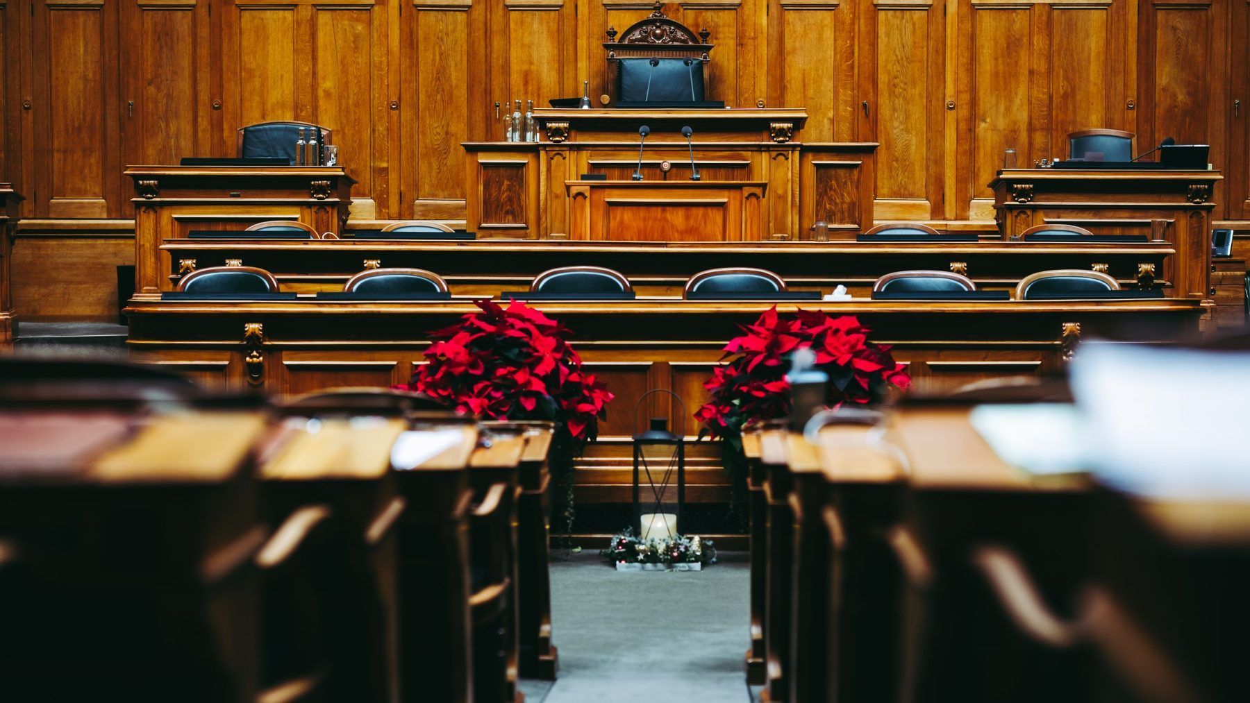 An empty courtroom seen from the back of the gallery