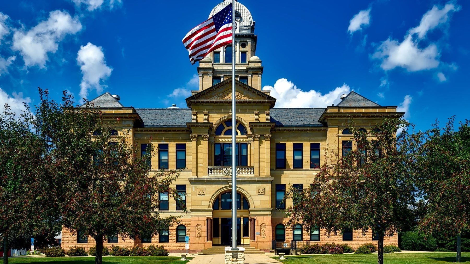 A county courthouse with a United States flag flying out front