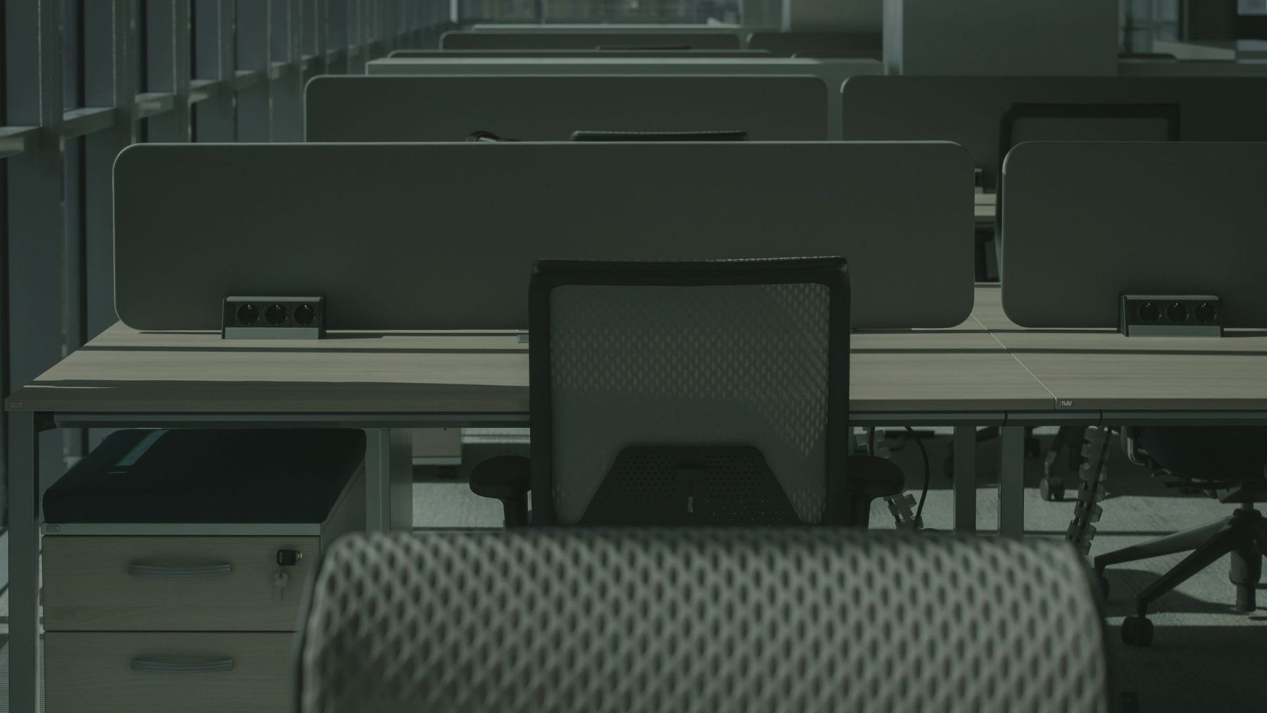 An empty open-plan office of desks after everyone has gone