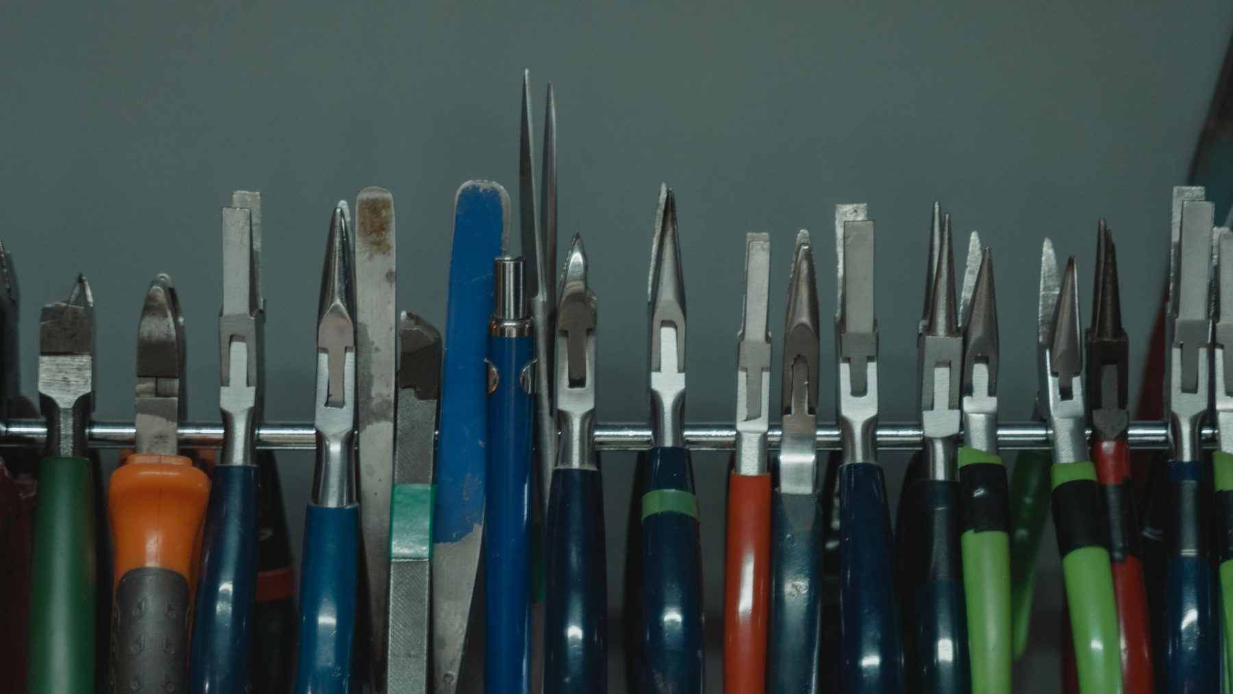 A rack of hand tools hung above a workbench