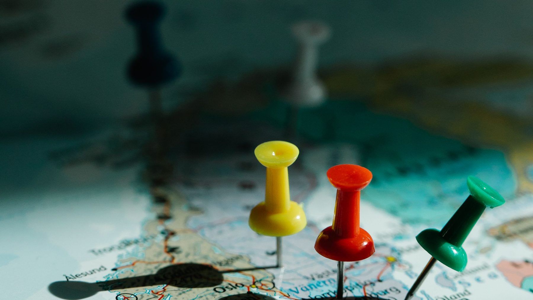 Colored pins pushed into a map