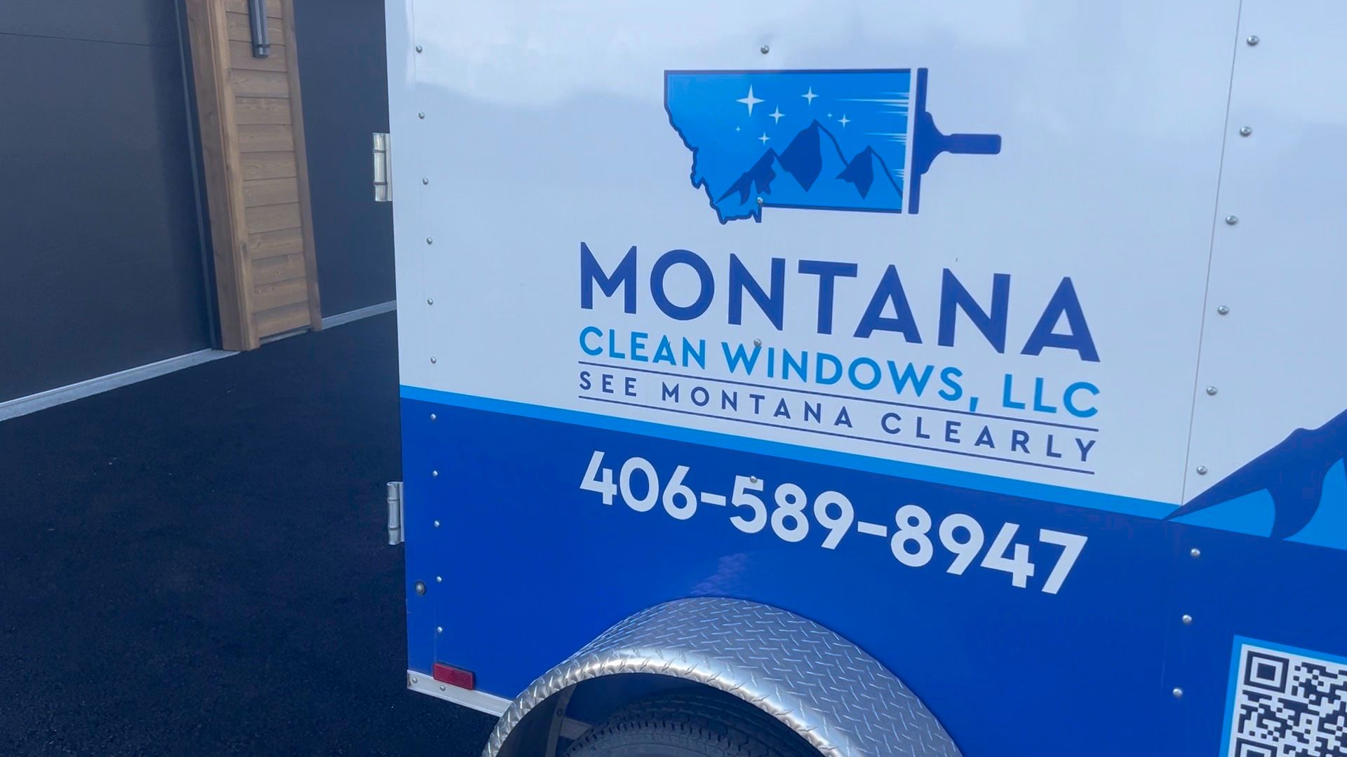 Montana Clean Windows LLC service truck with blue logo, phone number, and small QR code