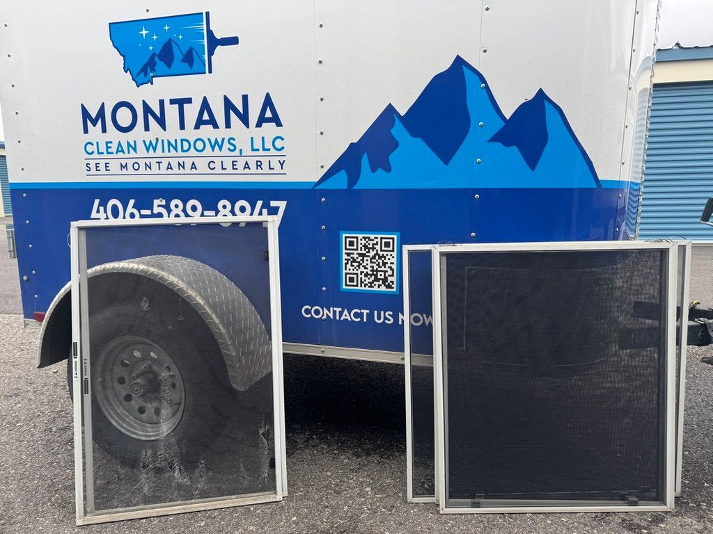 Montana Clean Windows van with blue mountain graphics and two framed display panels outside