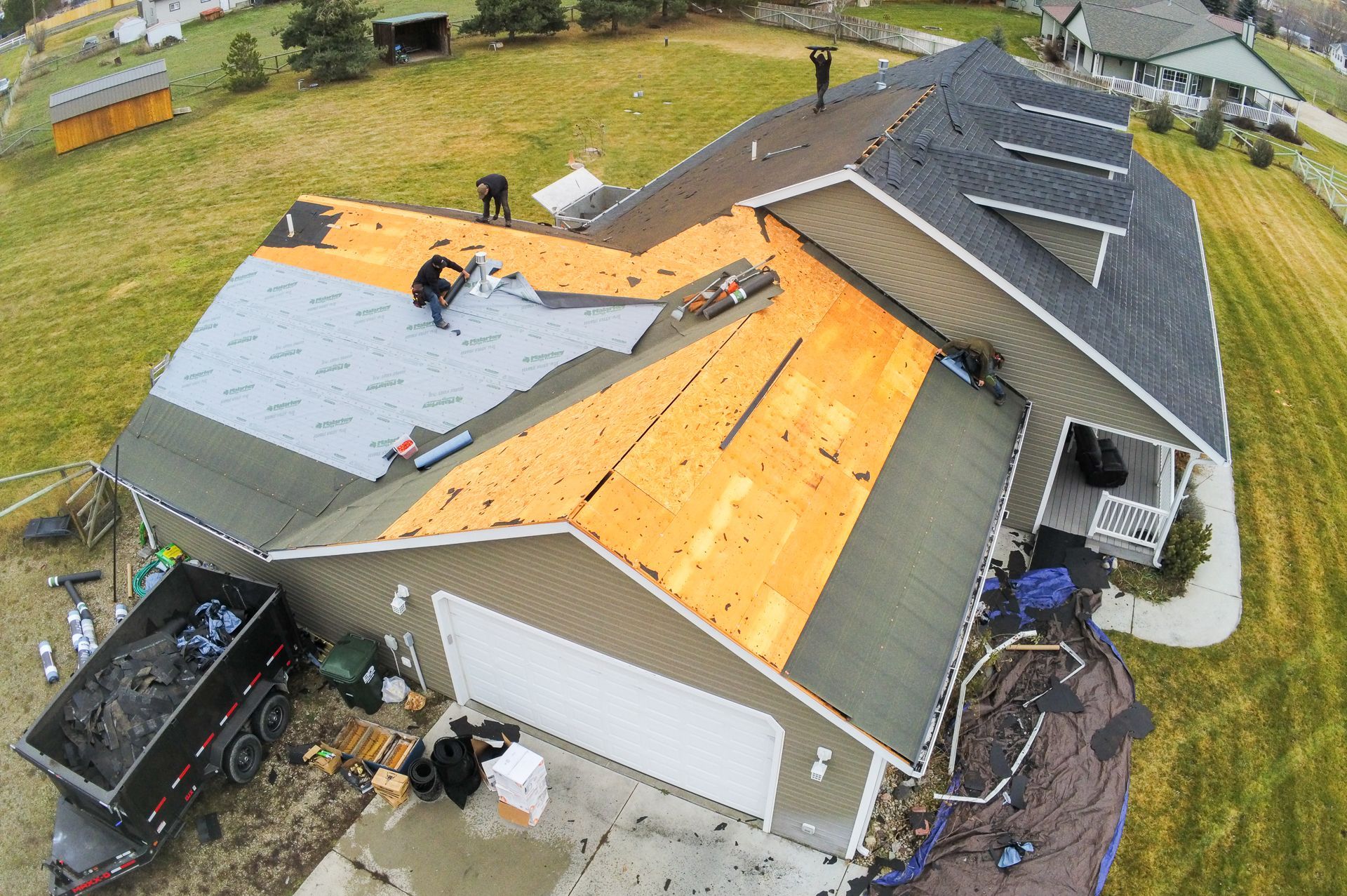 Residential roof replacement work in Schrock Roofing project imagery with homes and mountains in the background