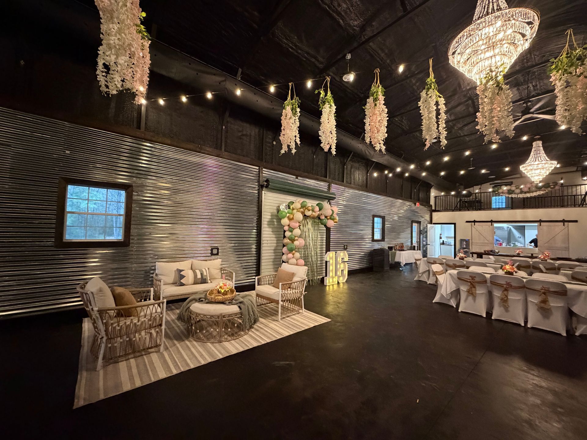 Elegant banquet hall with chandeliers, striped walls, and tables set for a formal event