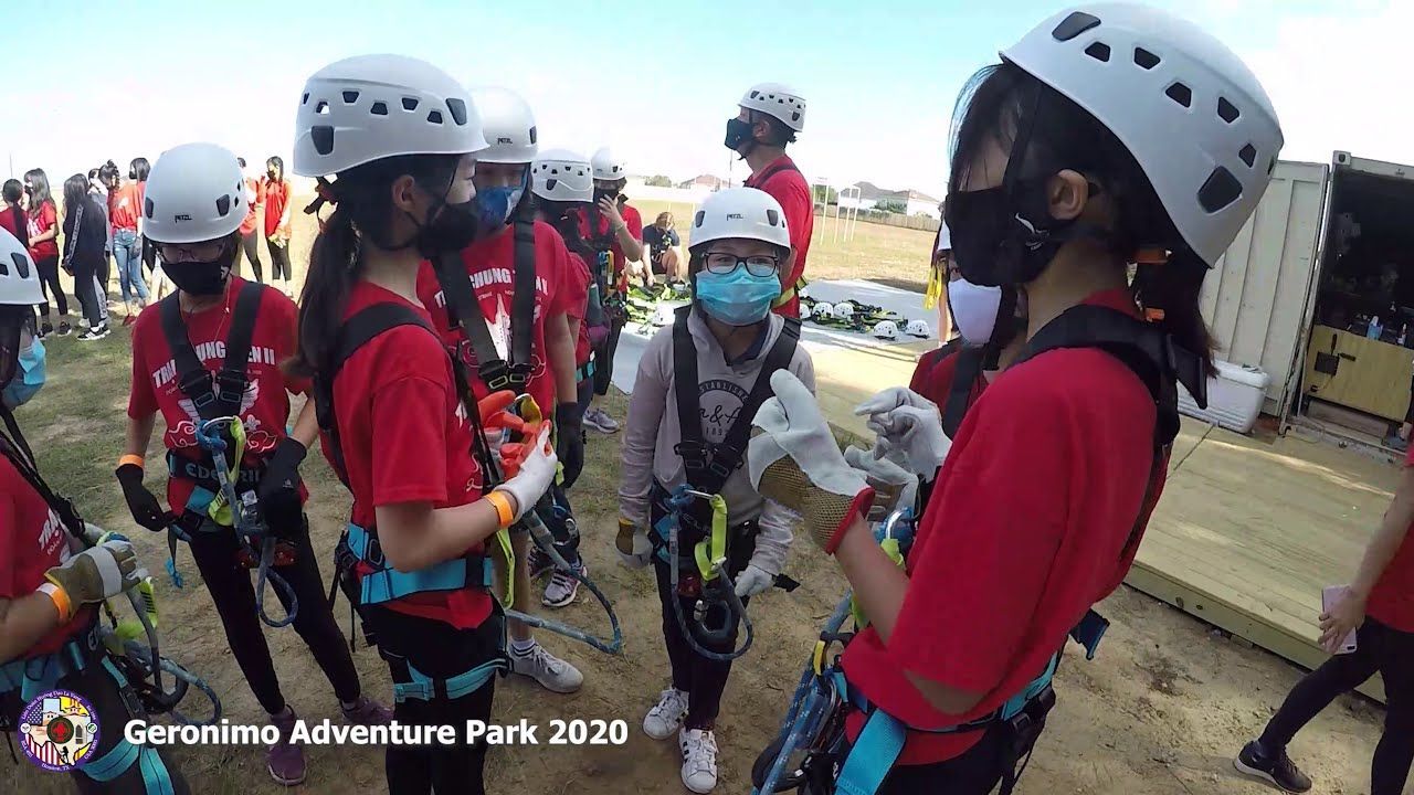 Children in helmets and harnesses gather outdoors at Jeronimo Adventure Park, 2020.