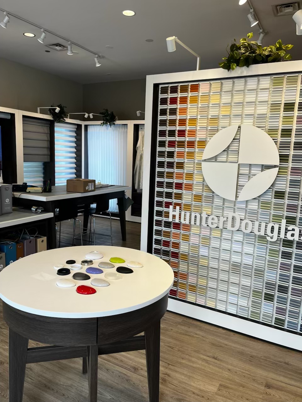 Interior of Hunter Douglas showroom; display of blinds, color samples, and logo.