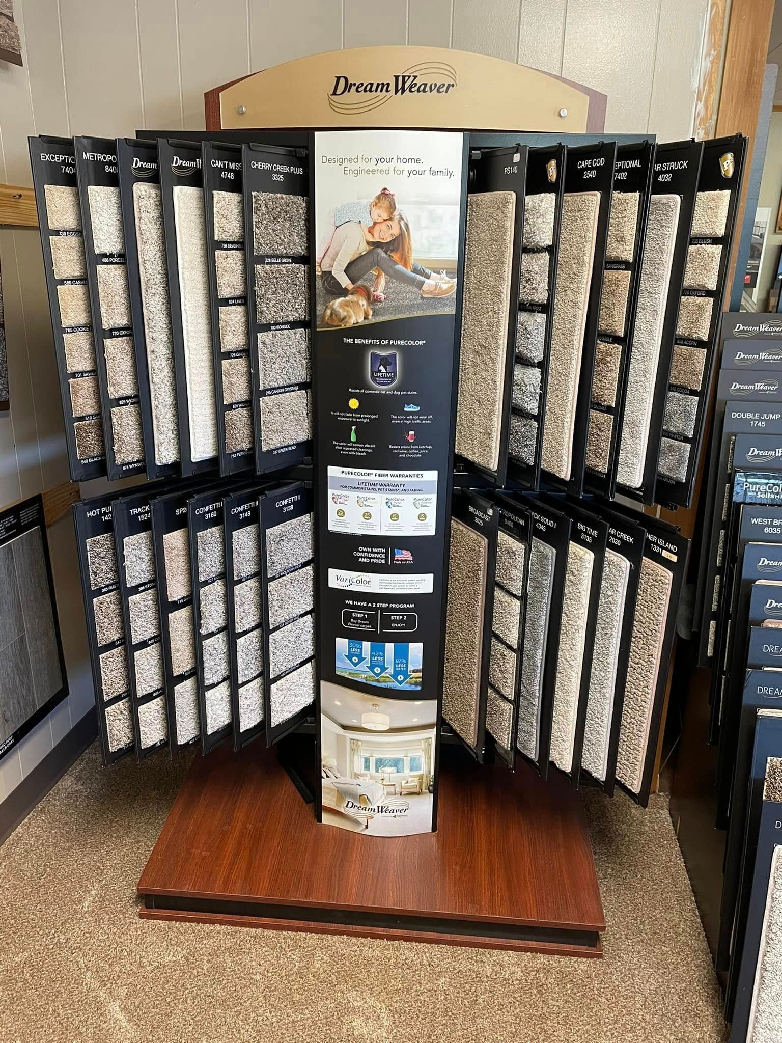 Rotating sunglasses display rack with many pairs and a central product sign in a store